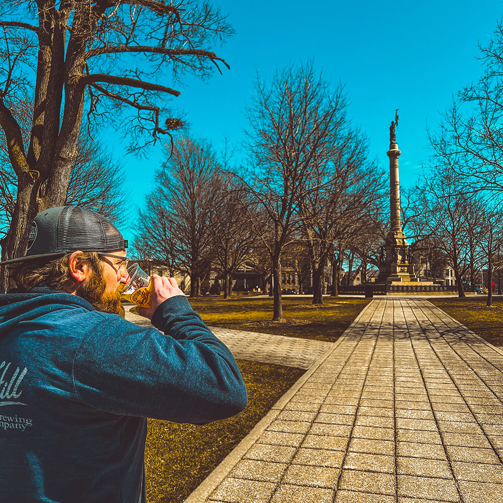 Image of a Pigeon Hill brewer enjoying Hackley Park and our community