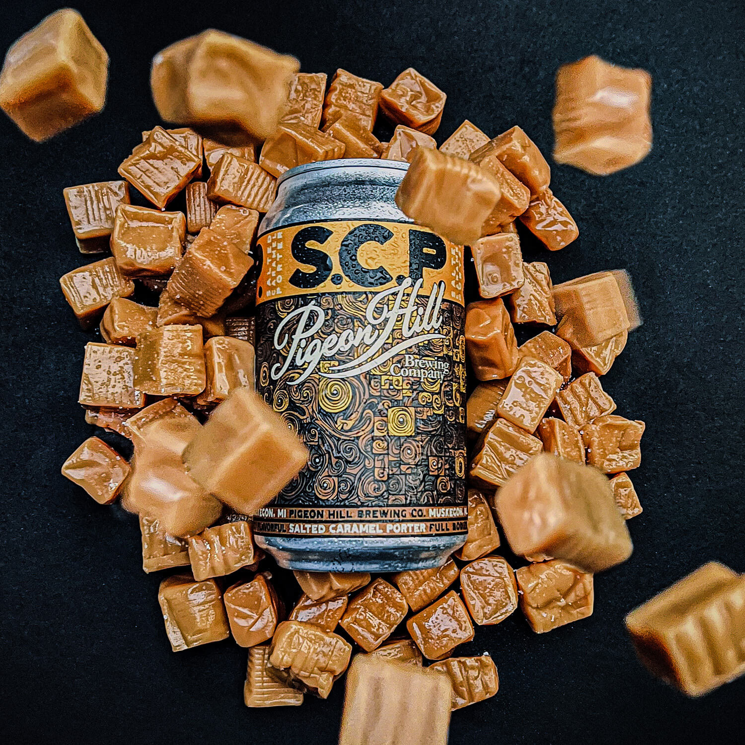 A can of Pigeon Hill Brewing S.C.P. covered in caramels.