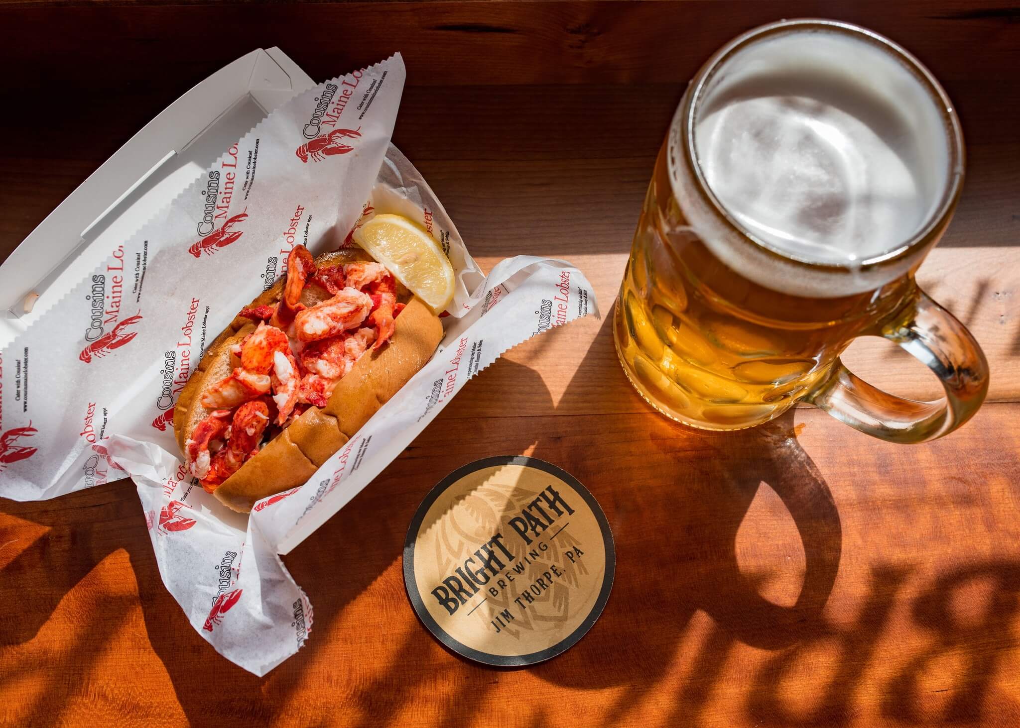 Photograph of food served by Cousins Maine Lobster along with beer