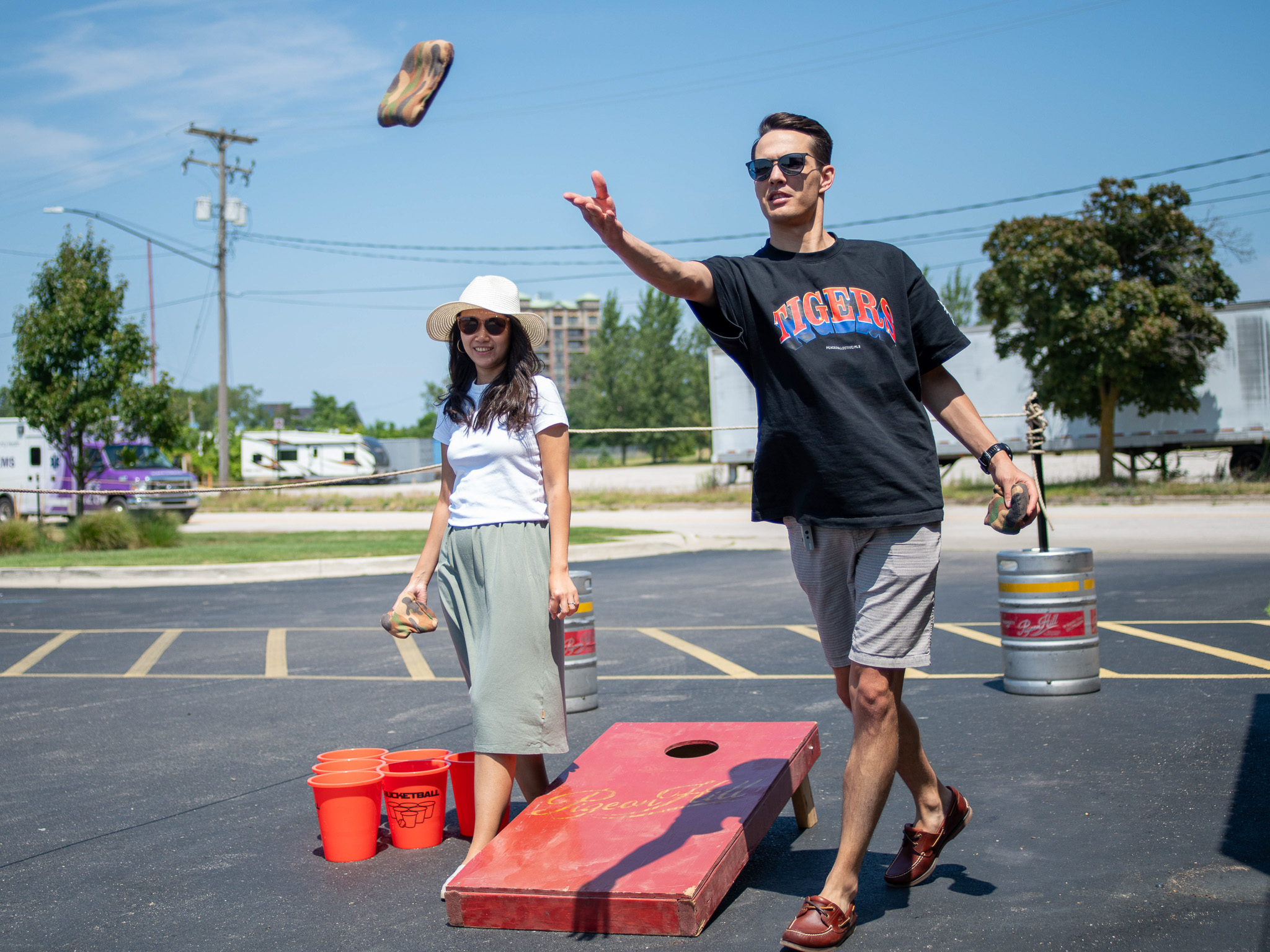 People playing cornhole on the patio at the Brewer's Lounge in Muskegon